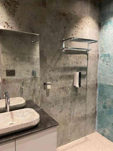 a bathroom with two sinks and a shower at Amara Kosha Misty Hills - Channa in Nandi