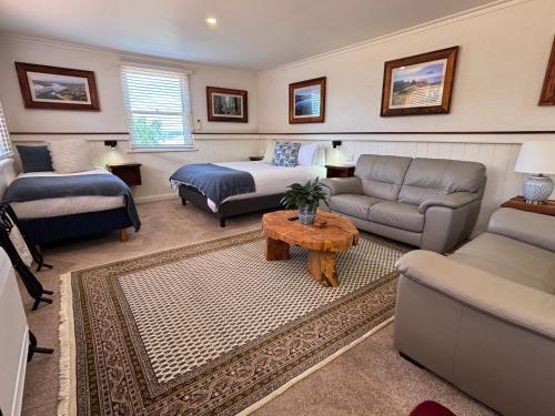 a living room with a couch and a bed at Silwood Apartment fully self contained with Kitchen and Laundry in Devonport