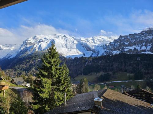 a view of a snow covered mountain from a house at Luxury Escape - Titlis Panorama in Engelberg