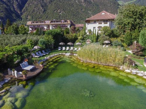 an aerial view of a house and a pool of water at Hotel Rössl in Rablà