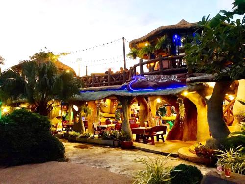 a building with a restaurant with a bridge at Happy Lagoon Bungalow in Khao Lak