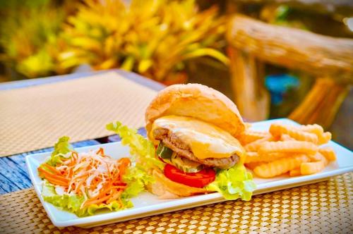 a plate of food with a sandwich and french fries at Happy Lagoon Bungalow in Khao Lak