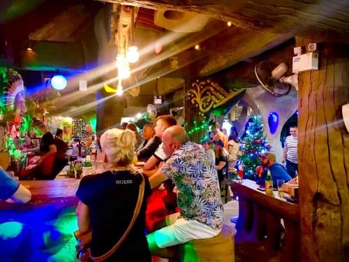 a group of people sitting at a bar at Happy Lagoon Bungalow in Khao Lak