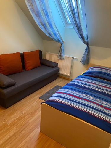 a living room with a couch and a bed at Fremdenzimmer Pehn in Ottenschlag