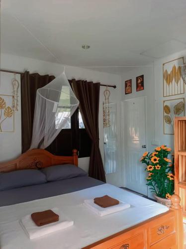a bedroom with a bed with two towels on it at Thip Bungalow in Ko Tao