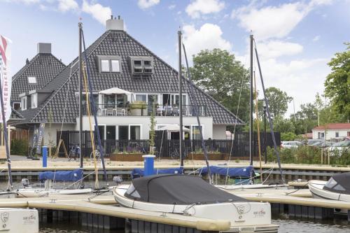a house with boats docked in a marina at Appartement Sneekermeer in Sneek