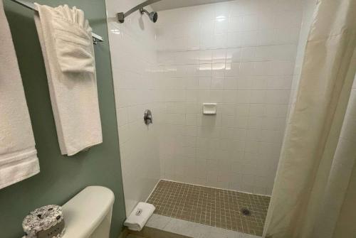 a bathroom with a shower and a toilet at Super 8 by Wyndham Peterborough in Peterborough