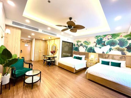 a hotel room with two beds and a painting on the wall at FLC Sea Tower Quy Nhon SeaView Condotel in Quy Nhon