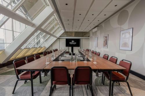 a large conference room with a long table and chairs at Hilton Paris La Défense in Puteaux