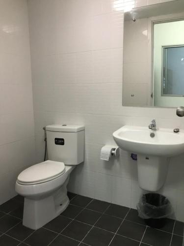a white bathroom with a toilet and a sink at Nido house in Ban Bang Phang