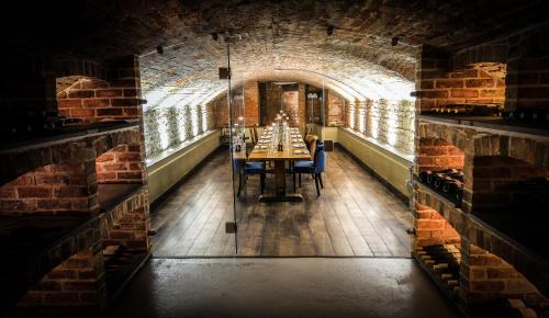 a dining room with a table in a brick wall at Kings Head in Cirencester