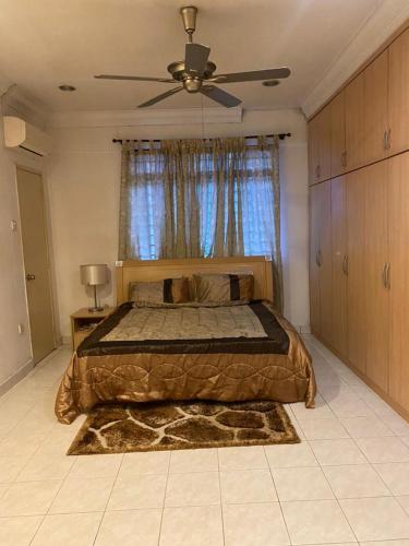 a bedroom with a bed and a ceiling fan at Cityscape KL in Kuala Lumpur