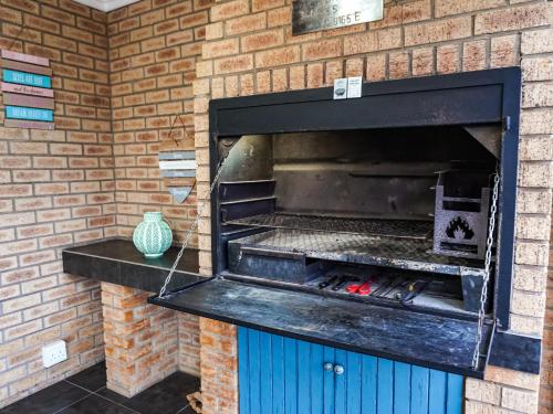 a brick wall with an oven with a grill at Barefoot Dreams 13A in Jeffreys Bay