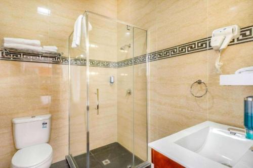 a bathroom with a shower and a toilet and a sink at Ramada by Wyndham, Hamilton City Center in Hamilton