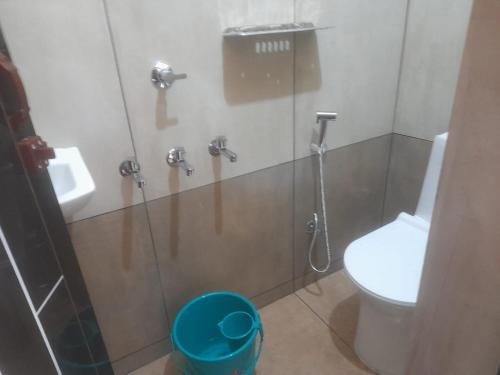 a bathroom with a shower with a toilet and a sink at AnanthaSayanam Homestay Near Sri Padmanabha Swamy Temple in Trivandrum