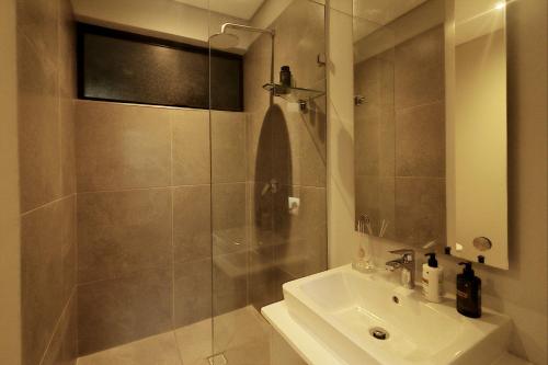 a bathroom with a shower and a sink at Ocean Club Zimbali Lakes Resort Ballito B13 in Durban
