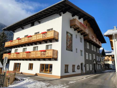 a building with wooden balconies on the side of it at Landhotel Steindlwirt in Dorfgastein