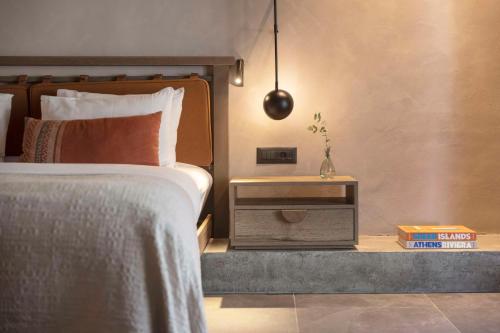 a bedroom with a bed and a nightstand next to a bed sidx sidx sidx at Lindian Village All Inclusive Resort Rhodes,Curio Collection in Kiotari