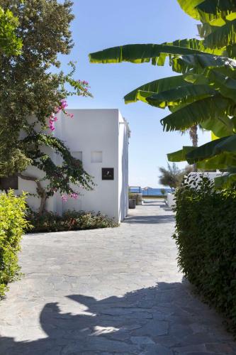 a shadow of a person standing next to a building at Lindian Village All Inclusive Resort Rhodes,Curio Collection in Kiotari