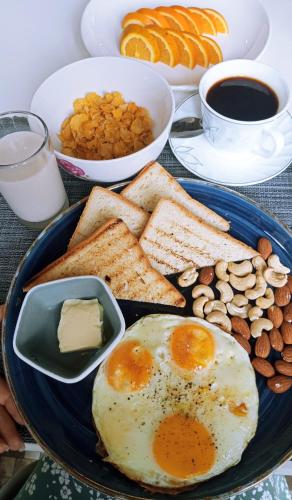a plate of breakfast food with eggs bread and nuts at Ahiva Village in Fulhadhoo