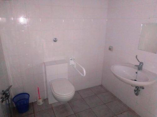 a bathroom with a toilet and a sink at Nuraghe Ruiu Villaggio Tende Attrezzate in Norbello