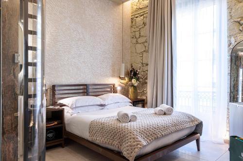 a bedroom with a bed with two towels on it at Naomi Nice in Nice