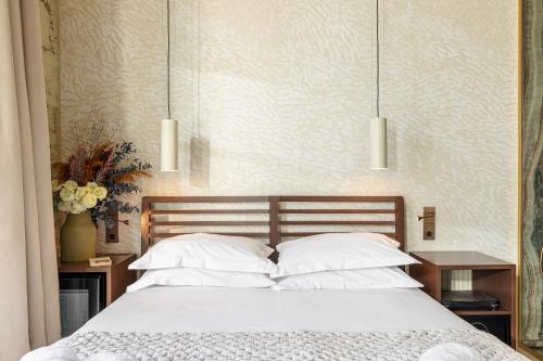 a bedroom with a bed with three pendant lights at Naomi Nice in Nice