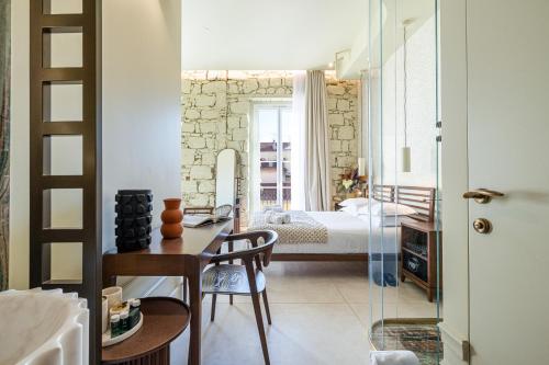 a bedroom with a bed and a table and chairs at Naomi Nice in Nice