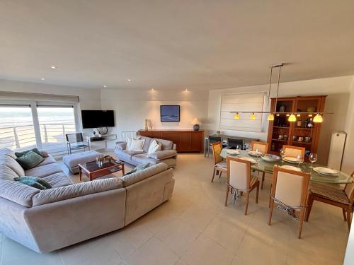 a living room with a couch and a table at Windjammer A3 - Sea View in Koksijde