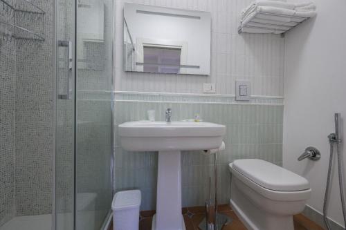 a bathroom with a sink and a toilet and a shower at Morrone Inn in Marano Marchesato