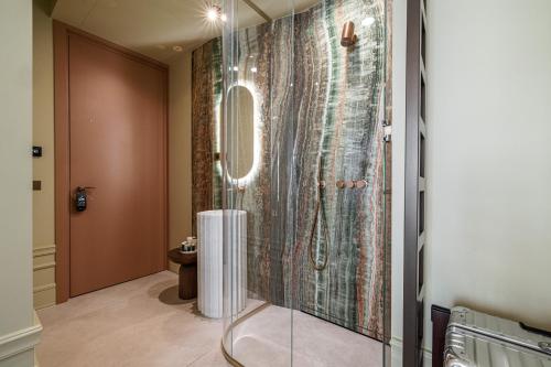 a bathroom with a shower with a glass door at Naomi Nice in Nice