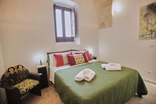 a bedroom with a bed with two towels on it at Chez Liart 1 in Fasano