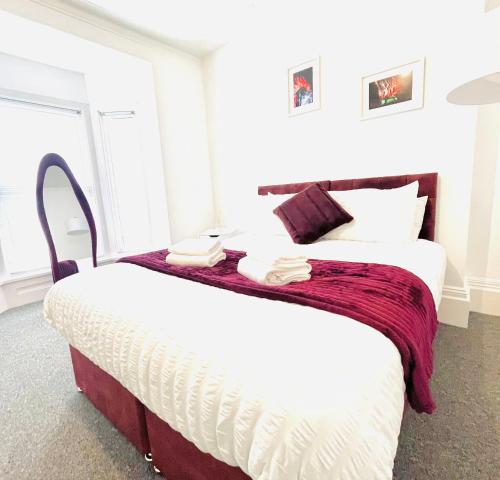 a bedroom with a bed with two towels on it at Clarence Road in Portsmouth