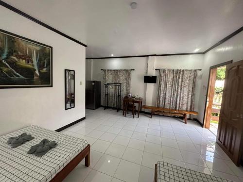 a living room with two beds and a table at Room 1 Family Fuego Island Guest House By Fuego Island Private Resorts in San Juan