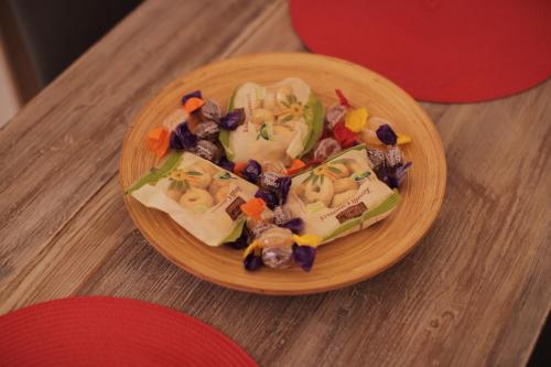a plate of food on a wooden table at Chez Liart 1 in Fasano