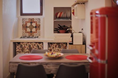 a table with chairs and a bowl of food on it at Chez Liart 1 in Fasano