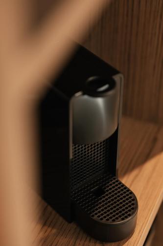 a black object sitting on a wooden table at Bronze Suites in Ioannina