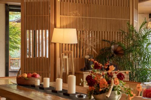 a table with candles and a vase of fruit on it at Xijiang Sanchunli Zhong Panorama Meisu in Xijiang