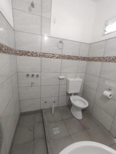 a bathroom with a toilet and a sink at Quinta El Medanito in Trinidad