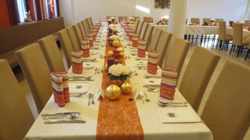 a long table in a dining room with chairs at Gasthof zur Sonne in Jettingen-Scheppach