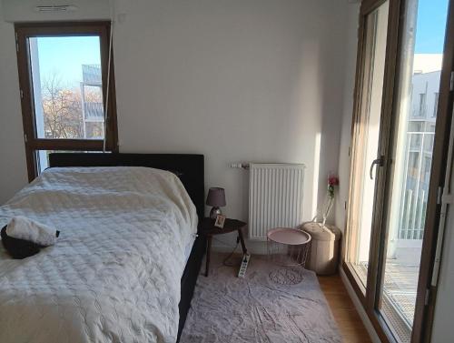a bedroom with a bed and a large window at Destiny Appart' Paris -Beauvais-Orly- Podcasts- Stade de France in Stains