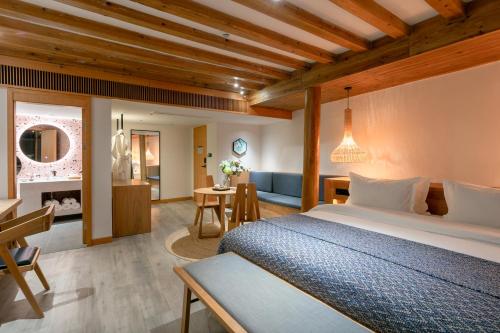 a bedroom with a bed and a living room at Xijiang Sanchunli Zhong Panorama Meisu in Xijiang