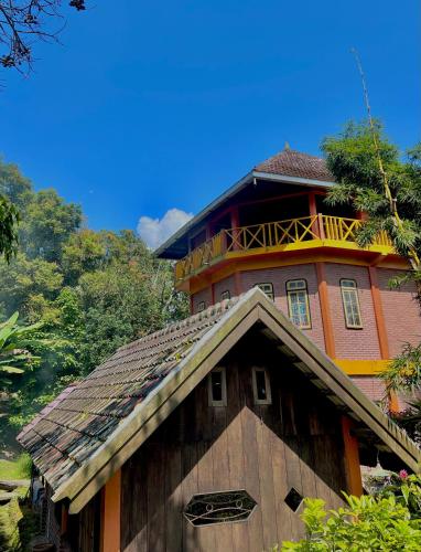 a wooden building with a tower on top of it at Swindo Homestay 77, Small House in Berastagi