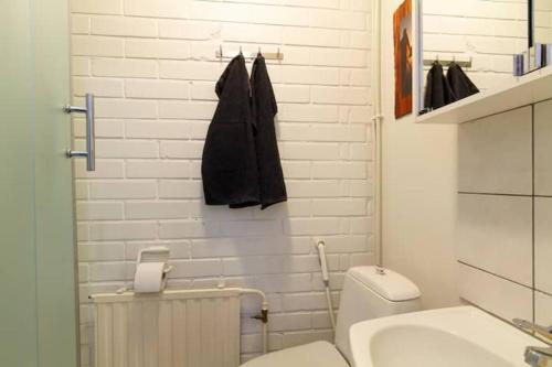 um banheiro branco com um vaso sanitário e uma pia em Studio Repo em Rovaniemi
