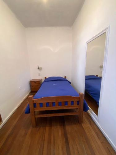 a bedroom with a bed and a large mirror at HostelCasaBlanca in Potosí