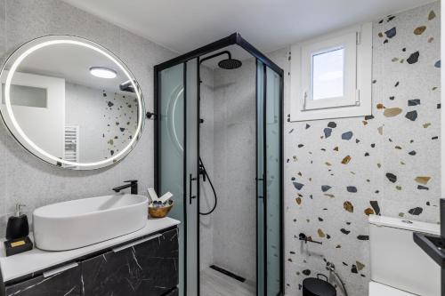 a bathroom with a sink and a mirror at Andromachi's house in Loutraki