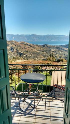 a table and chairs on a balcony with a view at Gerofotis Traditional Guesthouse est 1892 - Close to Aigio, Akoli, Selianitika in Lákka