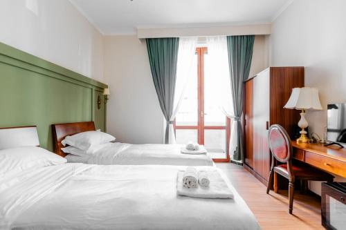 Postel nebo postele na pokoji v ubytování Modi Hotel