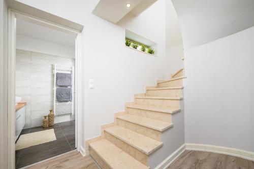 a staircase in a home with white walls and wood floors at Villa Chrisa Seaview in Piskopiano - Private Pool in Piskopianon
