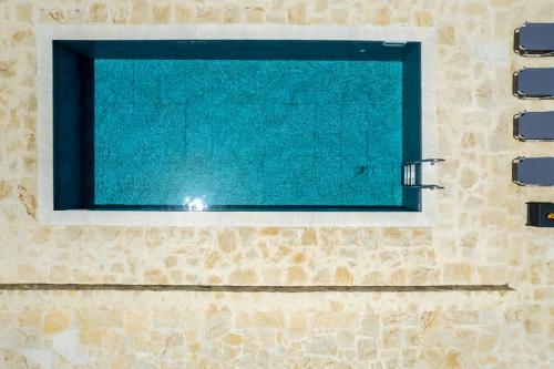 a window in a bathroom with a swimming pool at Villa Chrisa Seaview in Piskopiano - Private Pool in Piskopianon